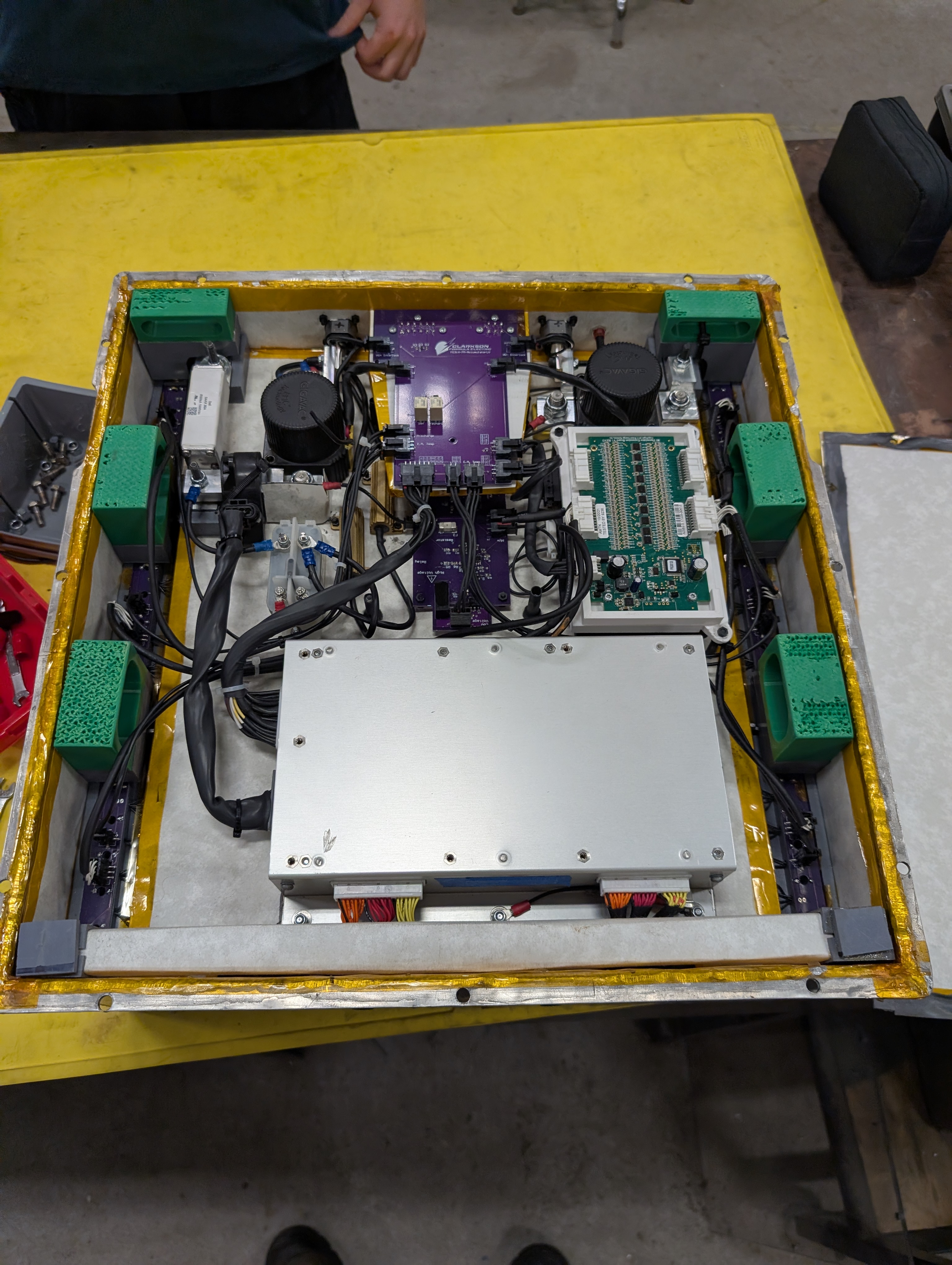 The accumulator container's internal electronics, including contactors, fusing, and battery-management boards