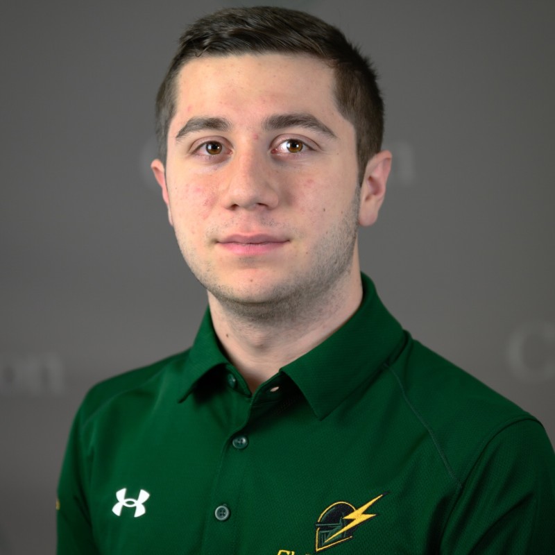 Frank Consolazio in a green Clarkson Formula Electric polo, against a grey backdrop