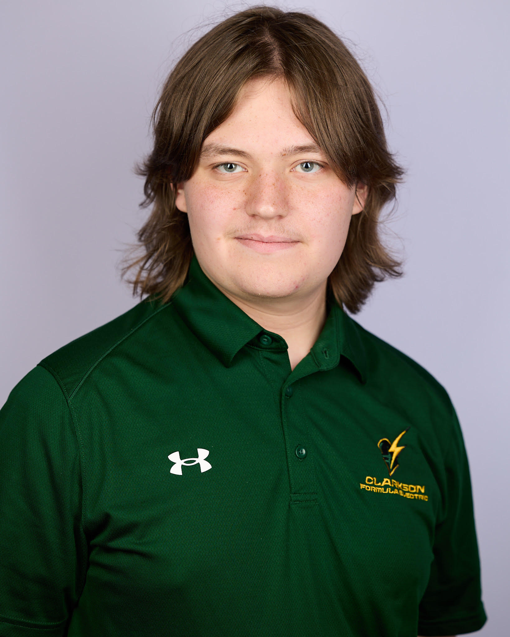 Ryan Withers in a green Clarkson Formula Electric polo, against a light grey backdrop